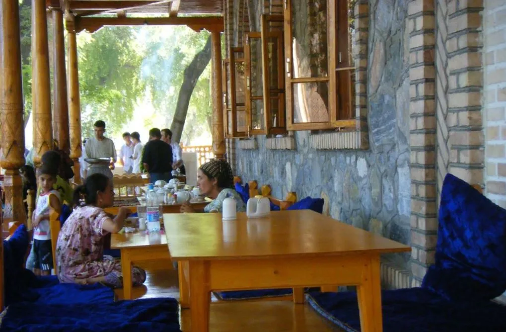 Two friends enjoying tea together in a traditional cafe, representing the social spirit of Yalla Choy.